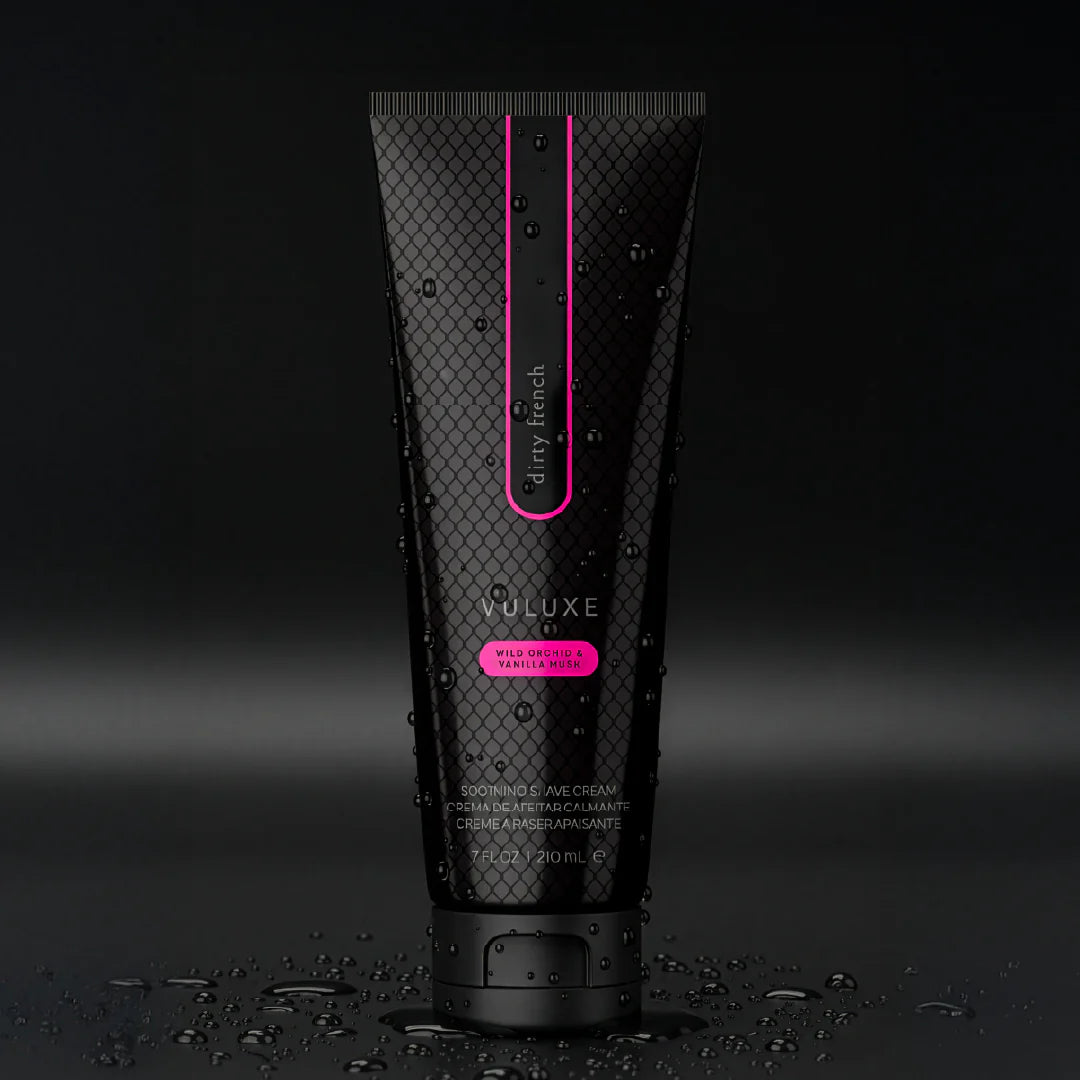 Black tube of VULUXE hair product with pink accents on a dark background. Vuluxe Coochy Shave Cream Rash free dirty french by pure romance www.VALGINA.com