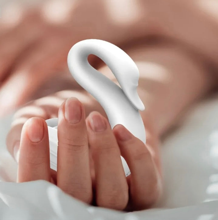 Lucy Goose, a white swan shaped vibrator for clitoral suction and vibration it is discreet incognito and comes with a stand for charging www.VALGINA.com