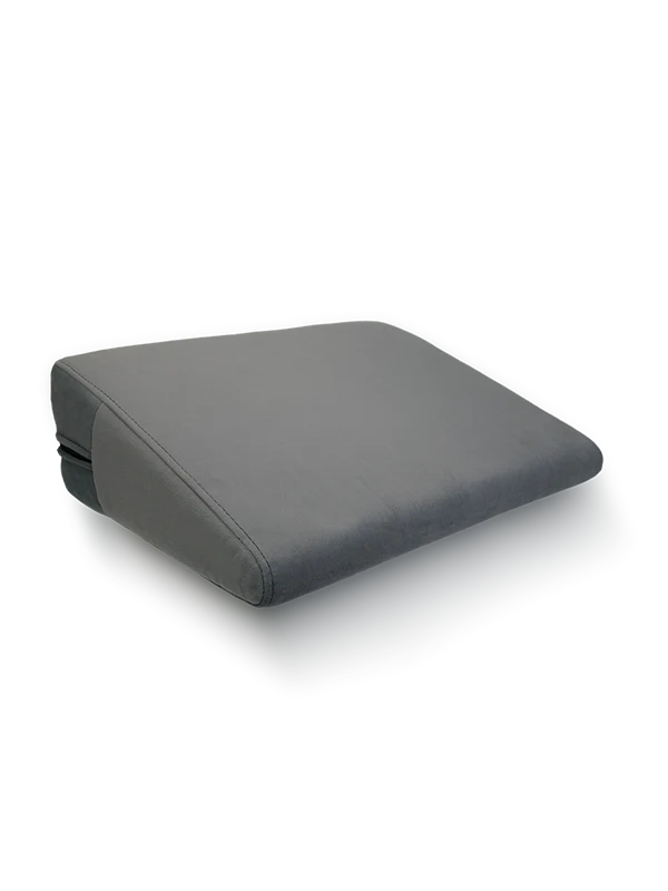 Position Wedge – Support Cushion for Elevated Intimacy. A gray wedge-shaped position wedge cushion with a soft, machine-washable cover. Best Couples sex pillow pure romance www.VALGINA.com