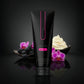 Black tube of VULUXE cream with pink accents on a dark background with flowers and cream. Vuluxe Coochy Shave Cream Rash free dirty french by pure romance www.VALGINA.com 
