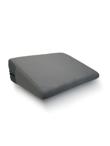 Position Wedge ‚– Support Cushion for Elevated Intimacy. A gray wedge-shaped position wedge cushion with a soft, machine-washable cover. Best Couples sex pillow pure romance www.VALGINA.com 