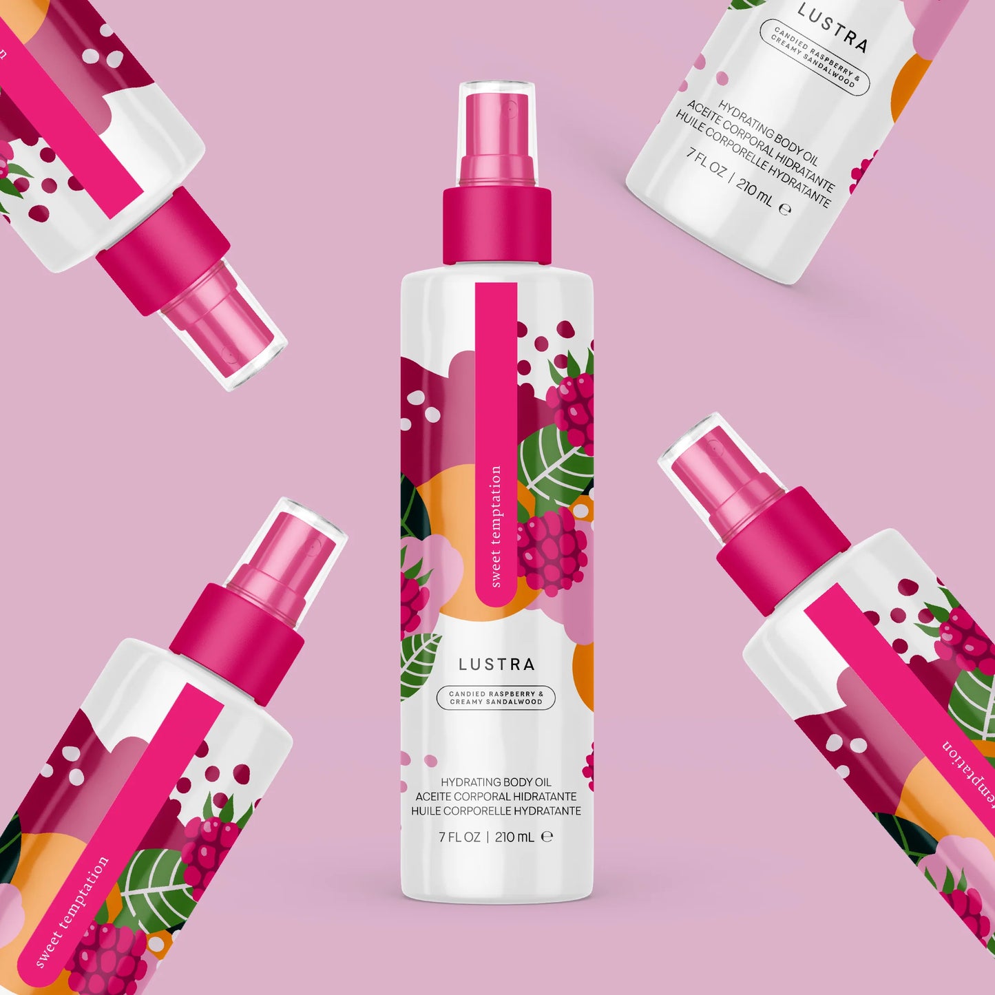 Lustra body oil bottles with pink sprayers on a pink background. lustra body dew sweet temptation sweet temptation pure romance www.VALGINA.com 