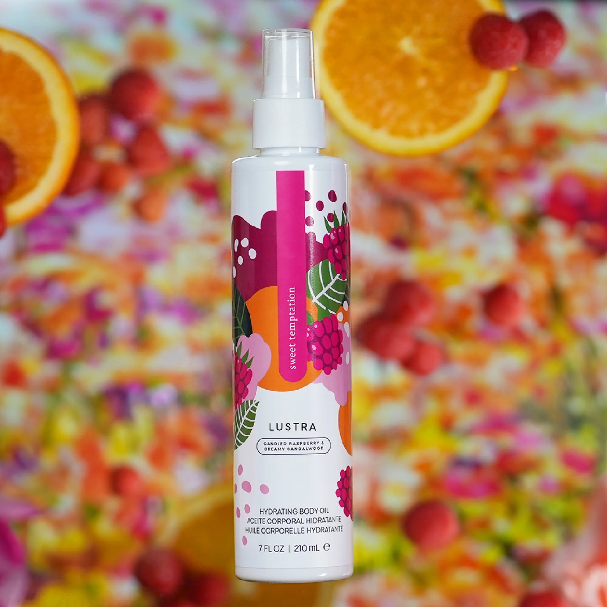 Lustra body oil bottle with a colorful fruit and berry background. lustra body dew sweet temptation sweet temptation pure romance www.VALGINA.com 