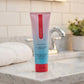 Tube of deodorant on a bathroom counter with a tiled wall background. no funks given full body deodorant niacinimide feminine odor www.VALGINA.com 