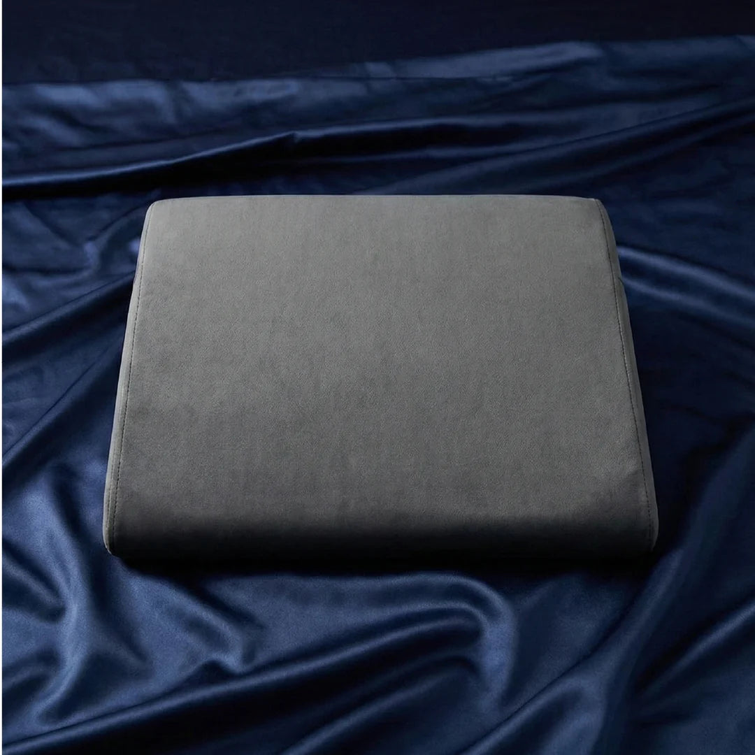 Position Wedge – Support Cushion for Elevated Intimacy. A gray wedge-shaped position wedge cushion with a soft, machine-washable cover. Best Couples sex pillow for positioning www.VALGINA.com 