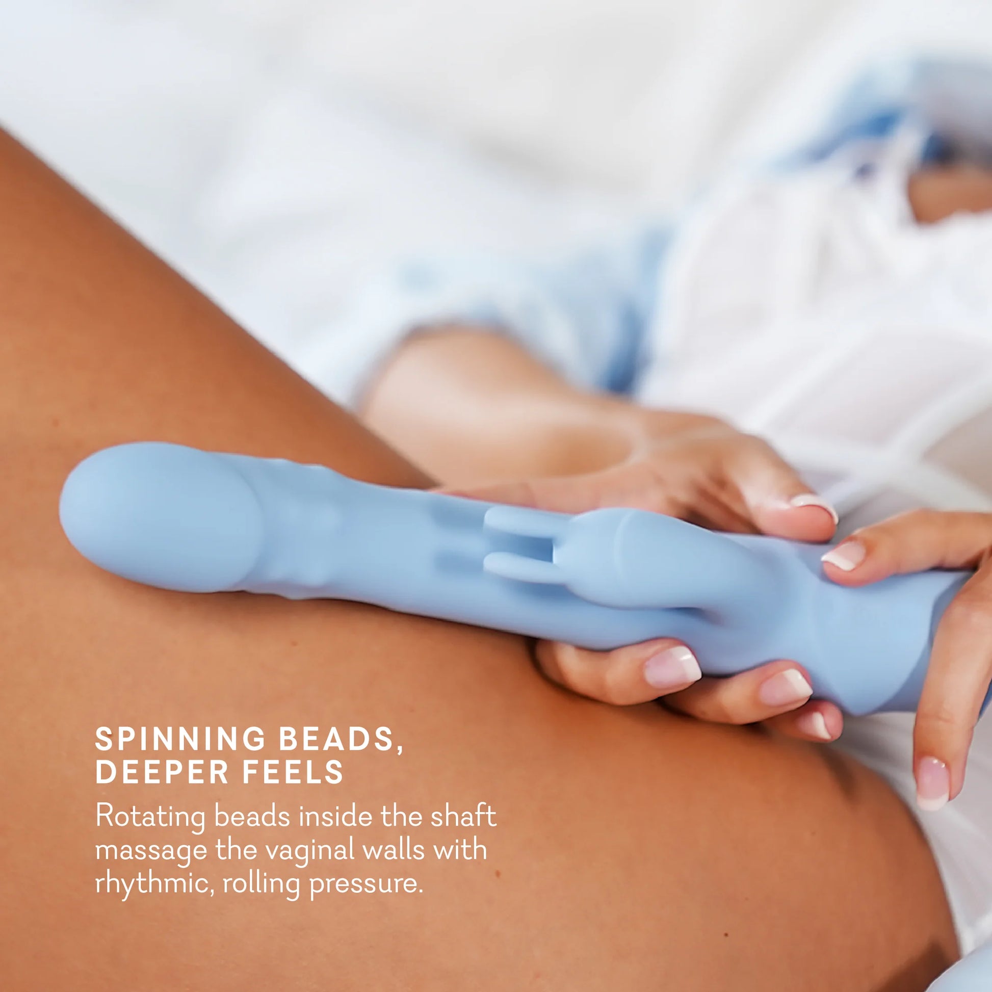 Blue silicone tool being held against a person's leg with text describing its features. t.o.m triple orgasm machine dual rabbit vibrator pure romance www.VALGINA.com 